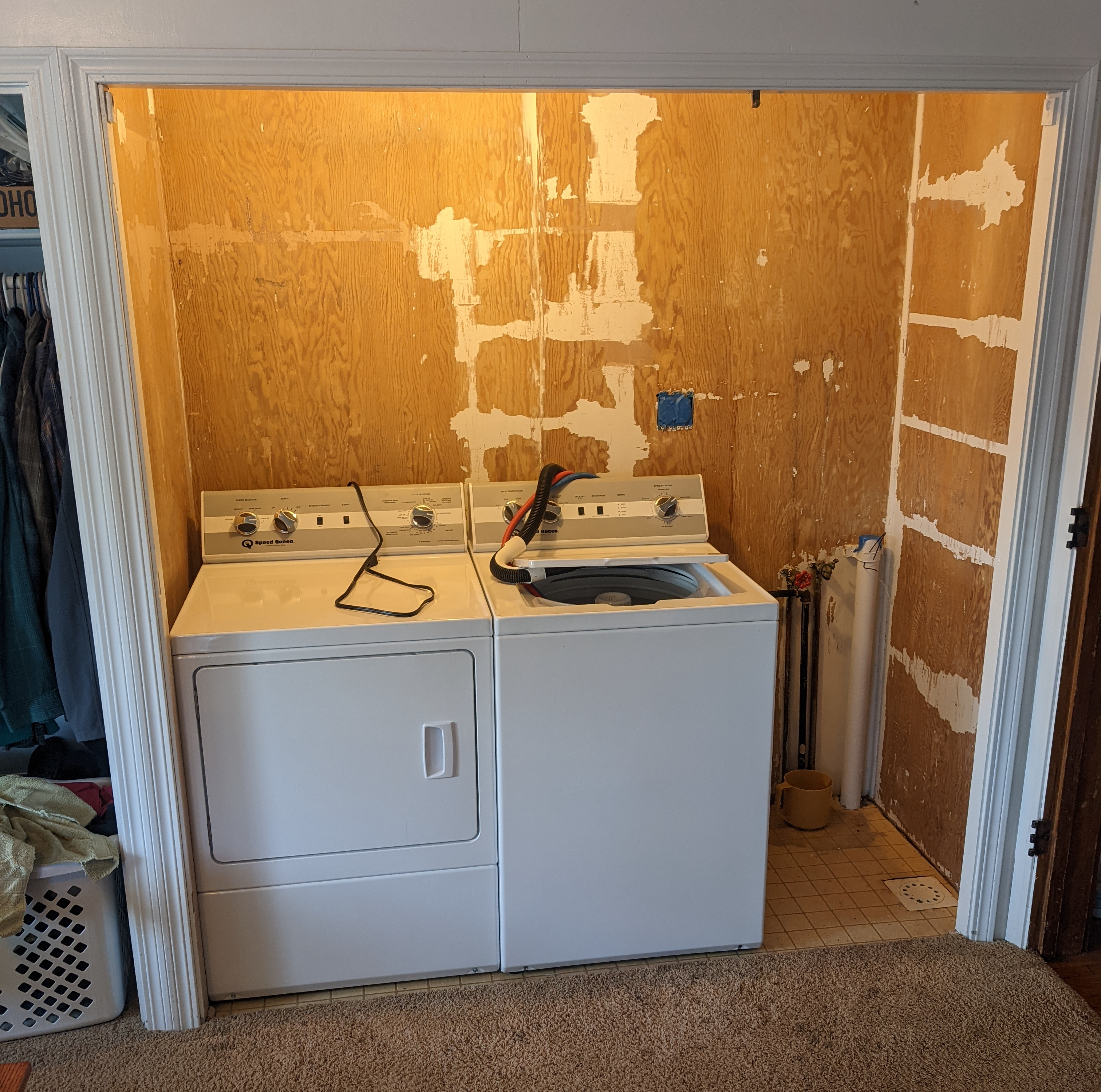 The laundry area closet after ripping out the old shelves and stripping the paint